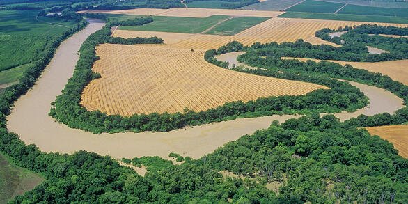 Aerial view of a river winding through farm fields